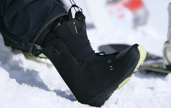Black Salomon snowboard boot in the snow. | © SALOMON