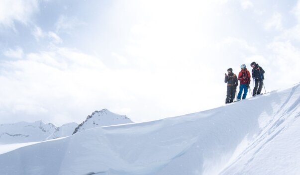 Skier jumping off a cliff in the snow. | © Tim Marcour