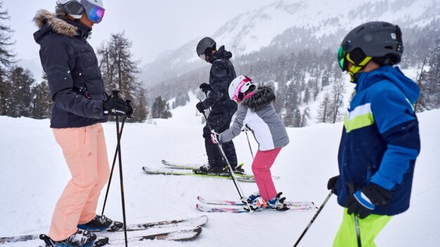 Family skiing in the snow.