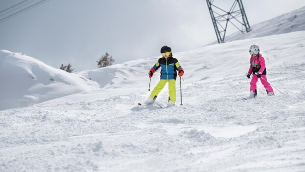Two children skiing on a snowy slope. | © IIC - INTERSPORT International Corporation GmbH