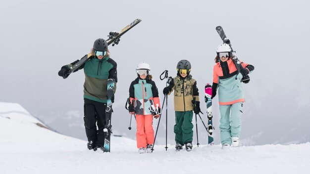 Four skiers in winter gear on a snowy slope. | © IIC/McKINLEY