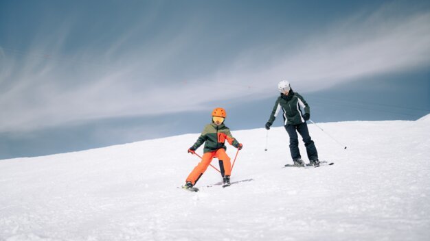 Two skiers on a snowy slope