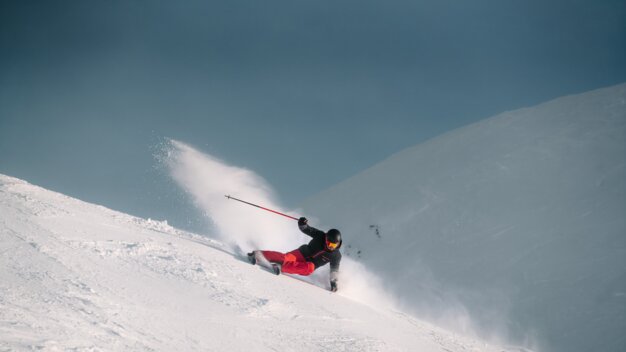 Skier carving in powder snow