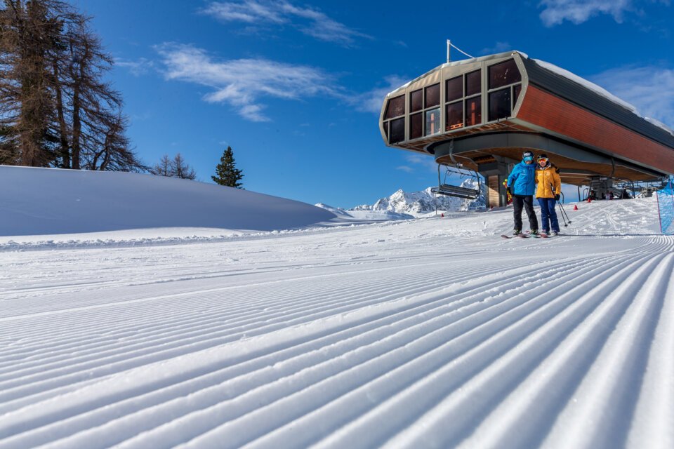Skiers at a gondola station on a freshly groomed slope. | © J. Kelagopian OTM NCA