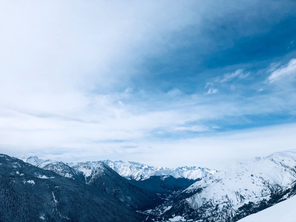 Snow-covered mountain range under blue sky