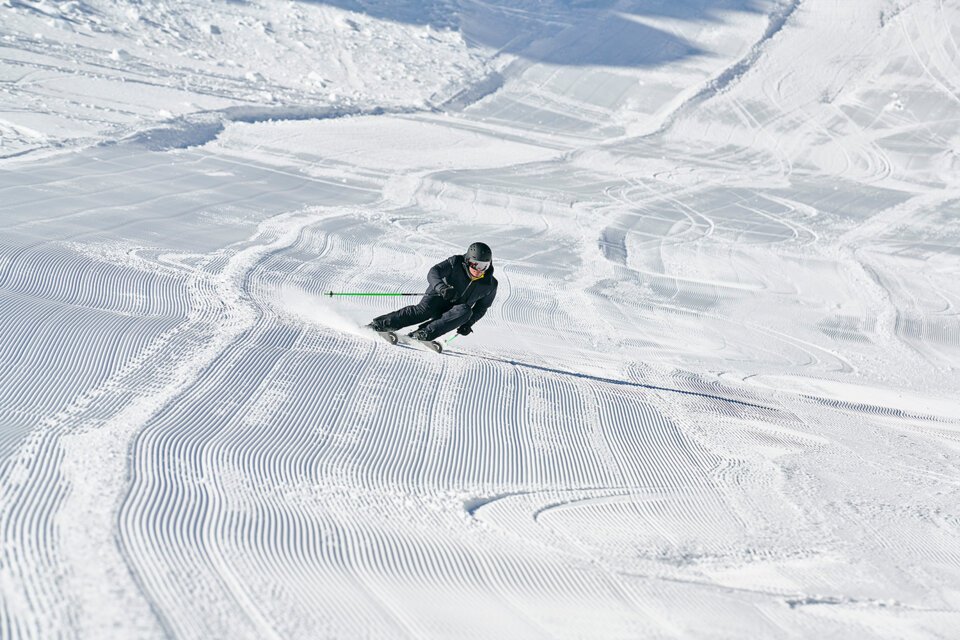 Skier on groomed slope