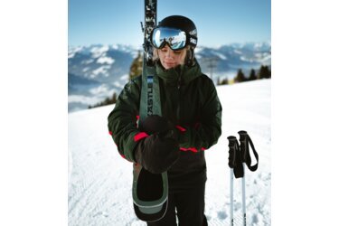 Skieuse avec des skis et des bâtons dans la neige.