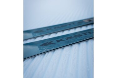 Two Kastle skis resting on freshly groomed snow.