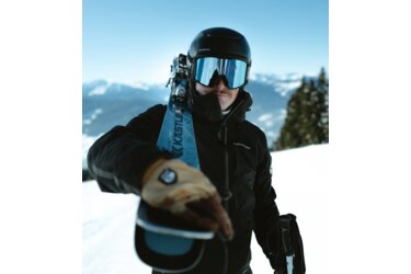 Skier with skis slung over his shoulder