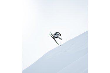 Skier jumping over a snow-covered slope.