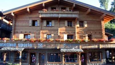 Wooden building with flower boxes and Intersport logo