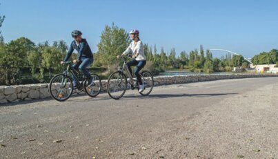 A couple is cycling on a path.