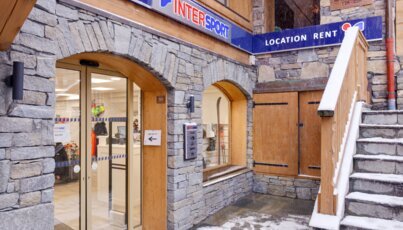 Entrance to an Intersport store with ski rental in winter.