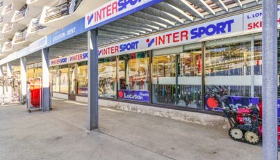 Intersport ski rental with a snow blower in front
