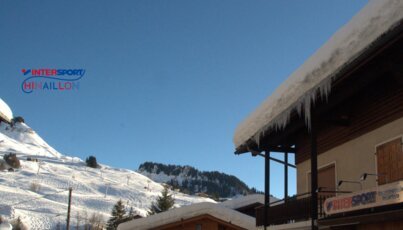 Winter scene with snow and an Intersport shop