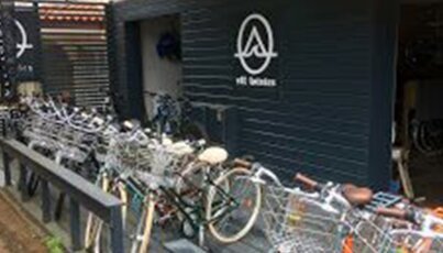 Bicycle parking with many bikes and a logo