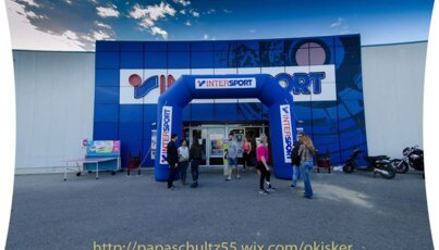 Intersport store with entrance arch and people in front