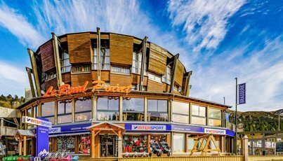 The 'Le Blend Point' building with Intersport store on a sunny day.