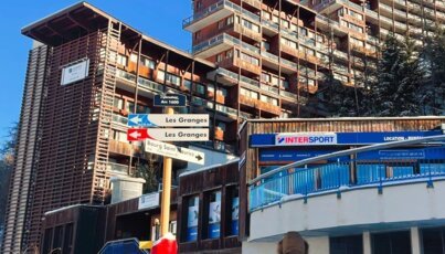 Signs at a ski resort point the way