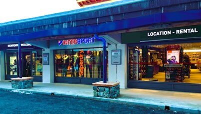 Exterior view of an Intersport store and a ski rental shop.