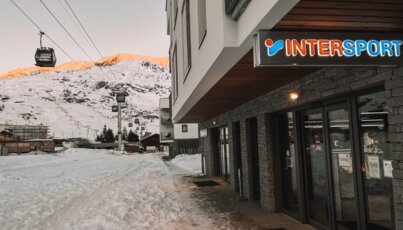 Intersport store in a snowy mountain landscape.