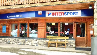 Intersport ski rental shop in a wooden building.