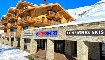 Intersport and ski storage in a wooden building in the snow.