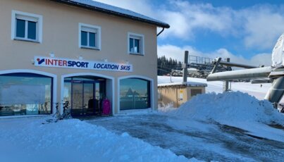 Intersport ski rental building on a sunny winter day.