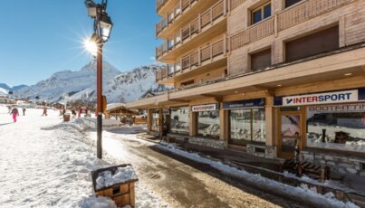 Ski resort with shops and snowy mountains