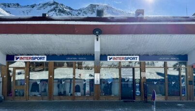 Intersport ski rental store with a mountain backdrop.